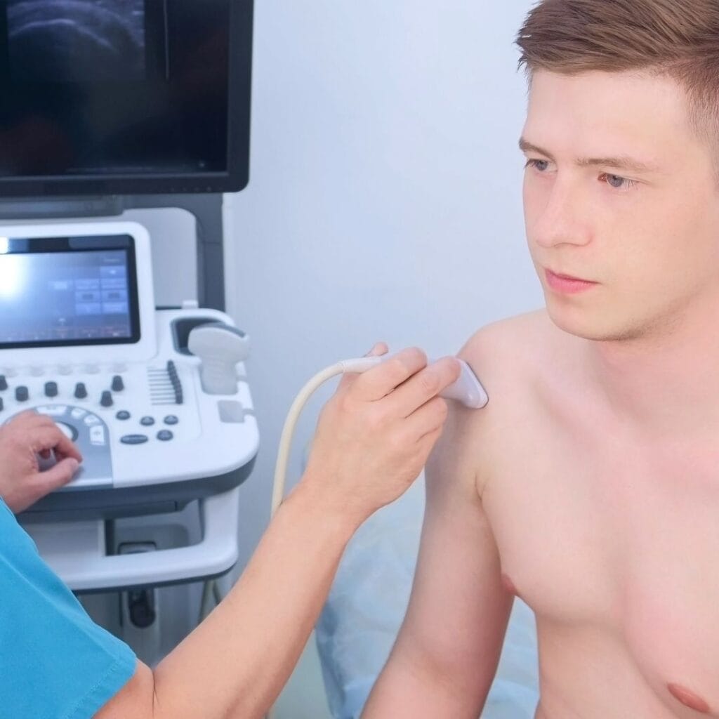 Zdjęcie przedstawia lekarza przeprowadzającego USG barku